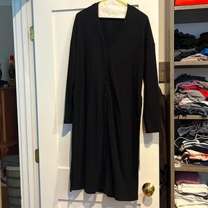 Long-sleeved waffle knit cardigan too with buttons and slits along the side.